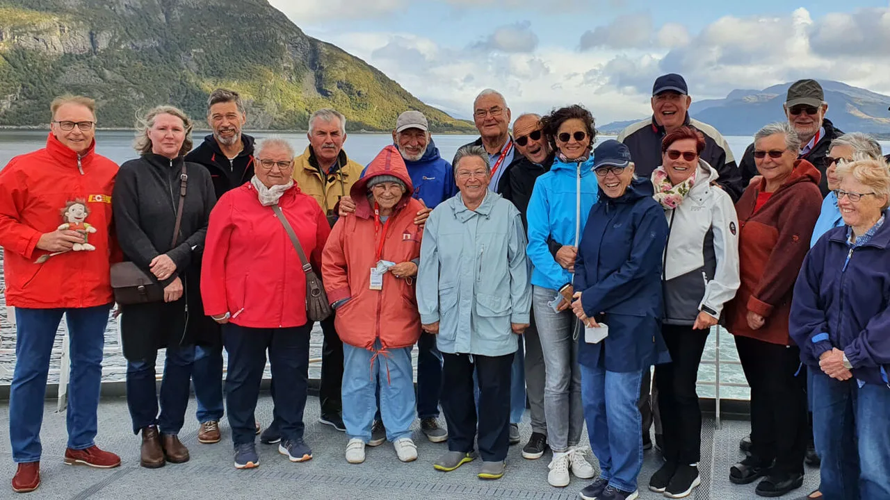 Menschengruppe vor Fjord